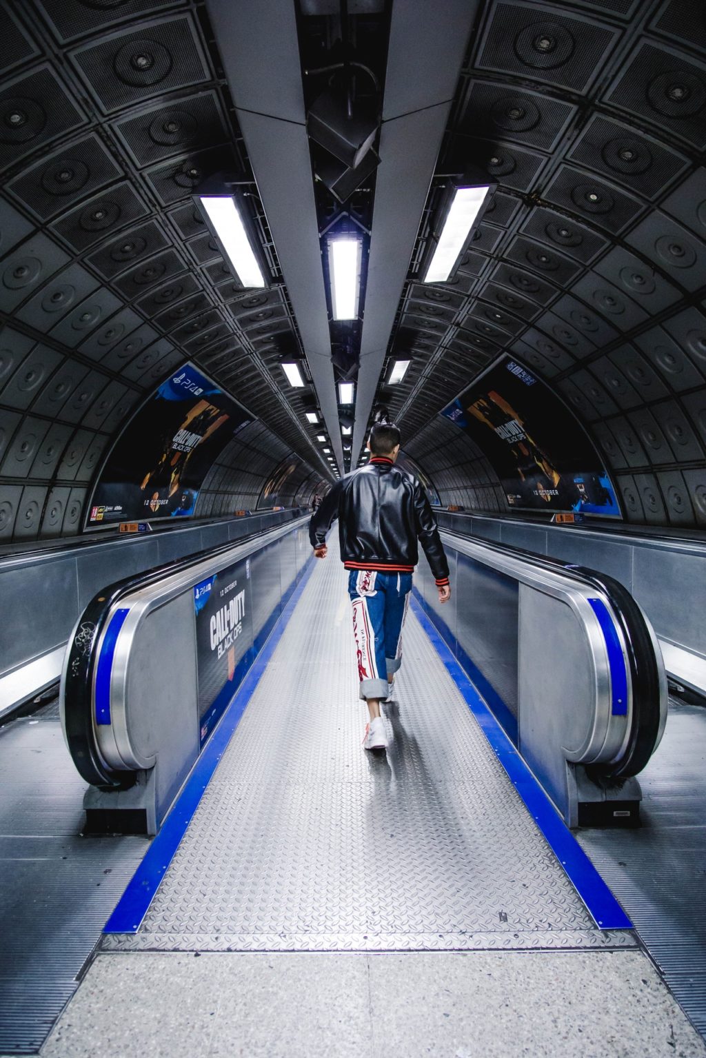 man walking on escalator