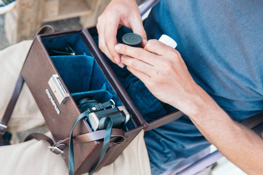 Man with film camera in bag.