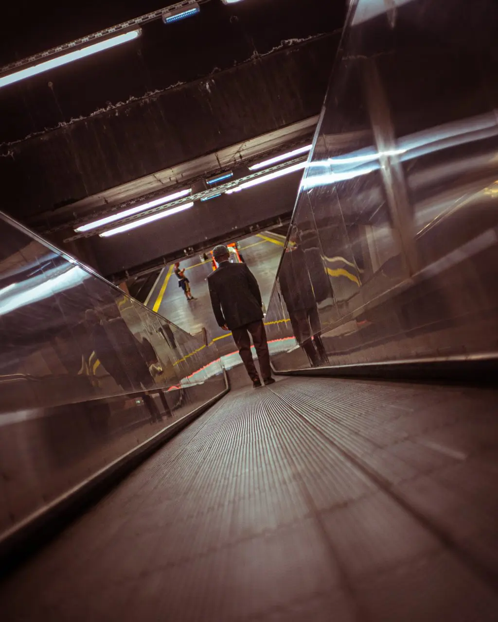 Dutch angle shot of man on travelator with Dutch Angle 