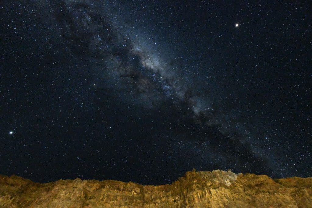 Night sky over a cliff