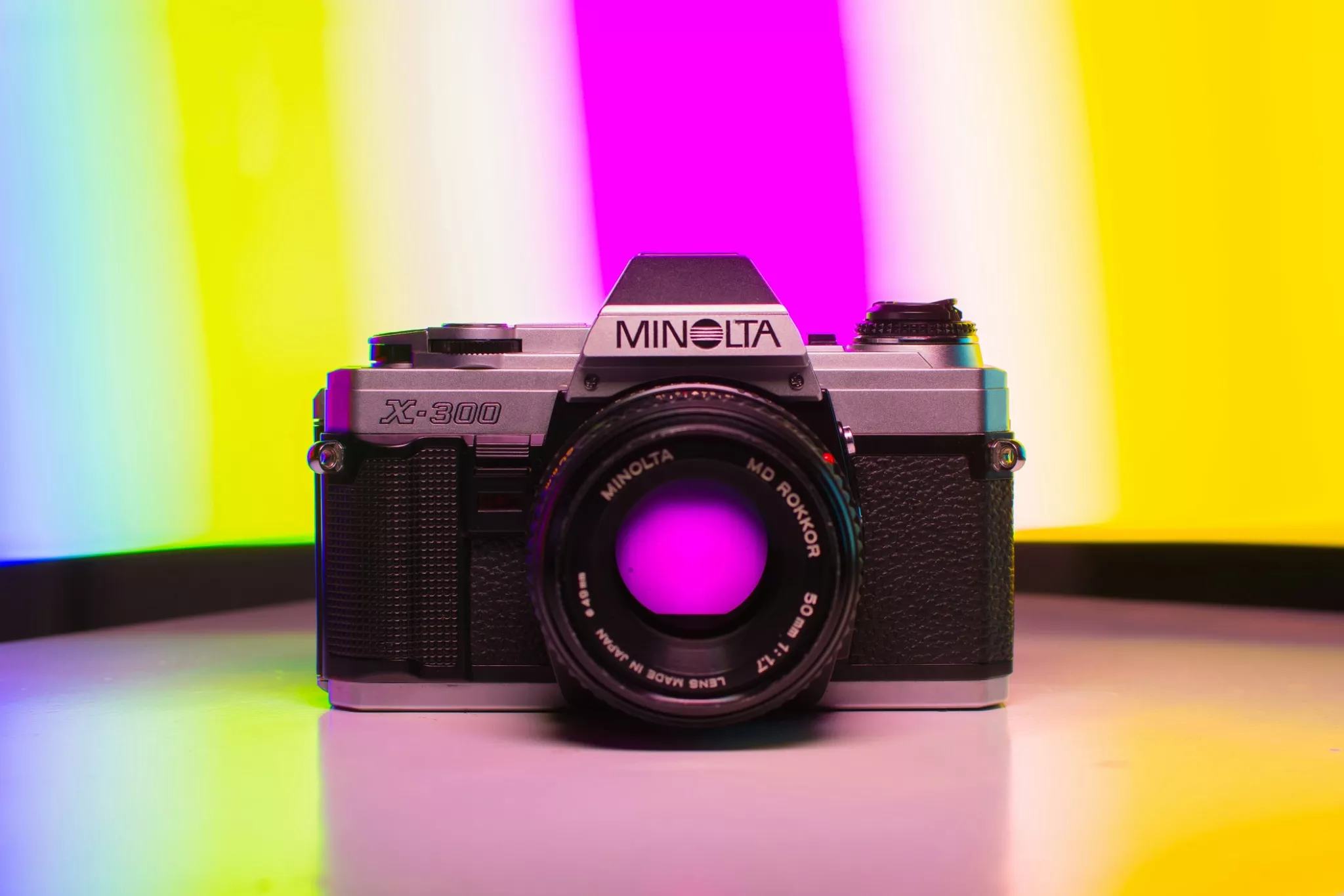 Minolta X300 film camera on bright colourful background 