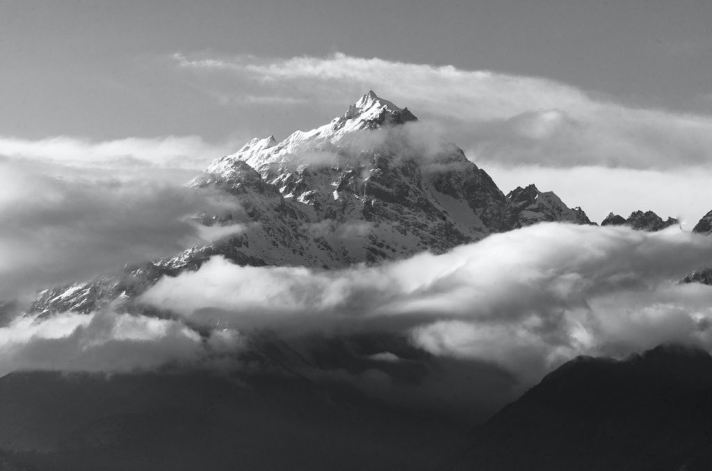 monochrome photo of snow capped mountains during daytime