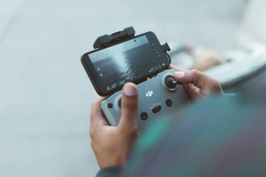 Remote pilot holding controller for drone.