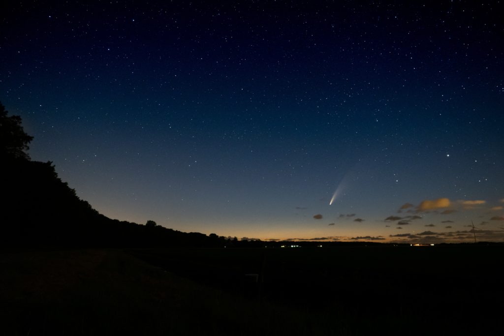 Comet in front of silhouette foreground