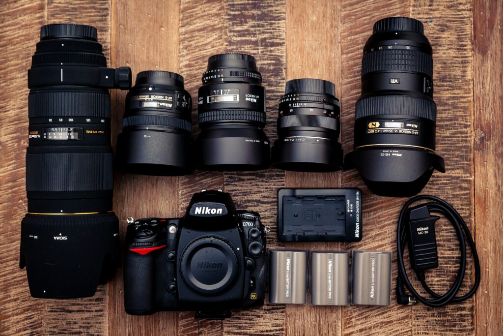 A Nikon camera with multiple lenses on a desktop 