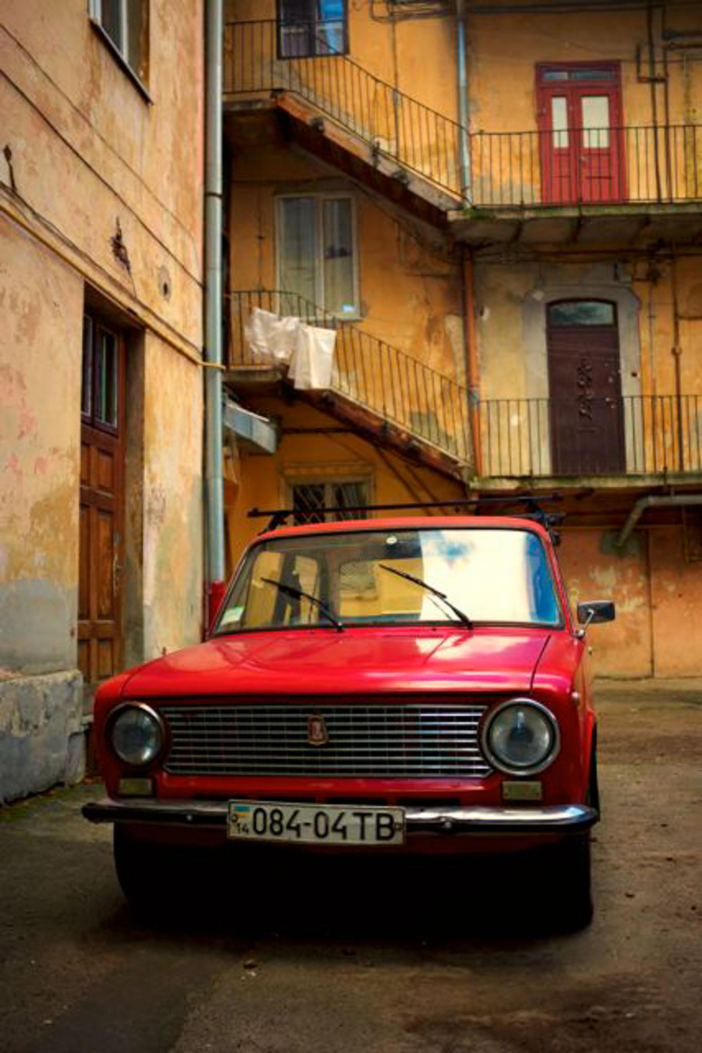 Old red Lada in a courtyard in Lviv, Ukraine 
