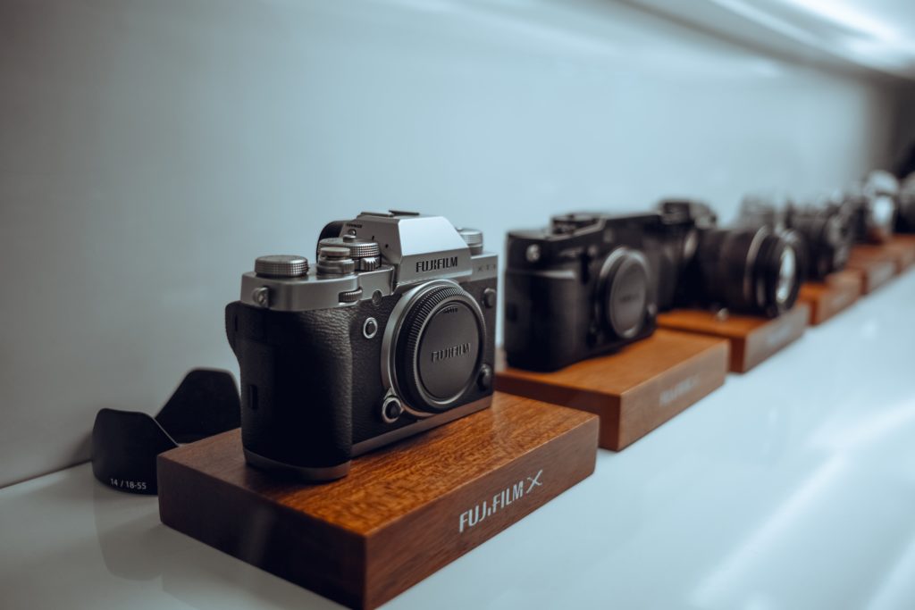 Line of Fuji cameras on shelf 