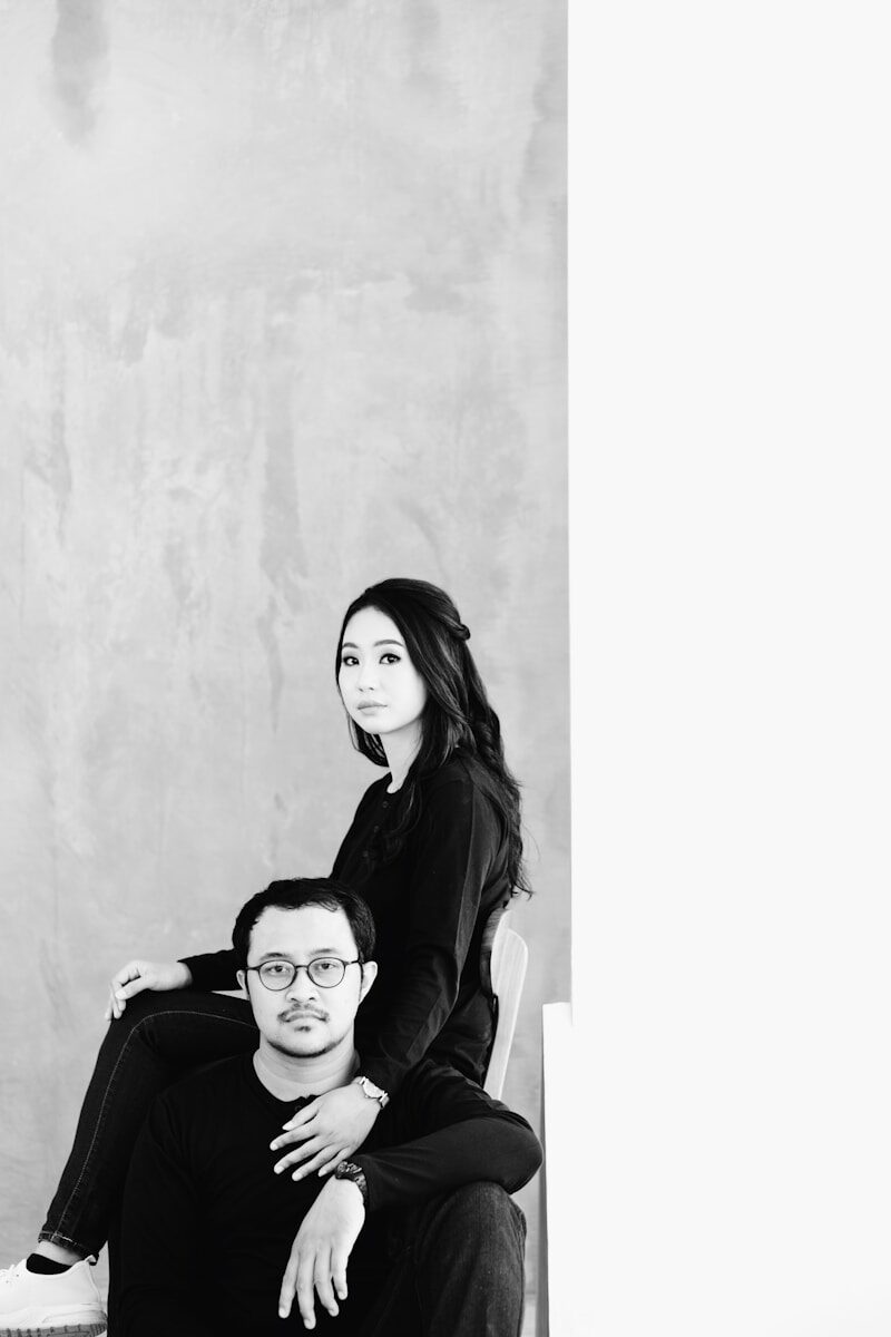 a man and a woman sitting on a chair