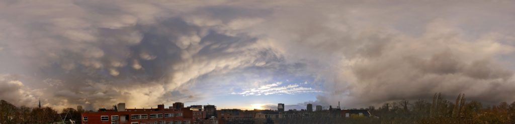 city buildings under white clouds during daytime