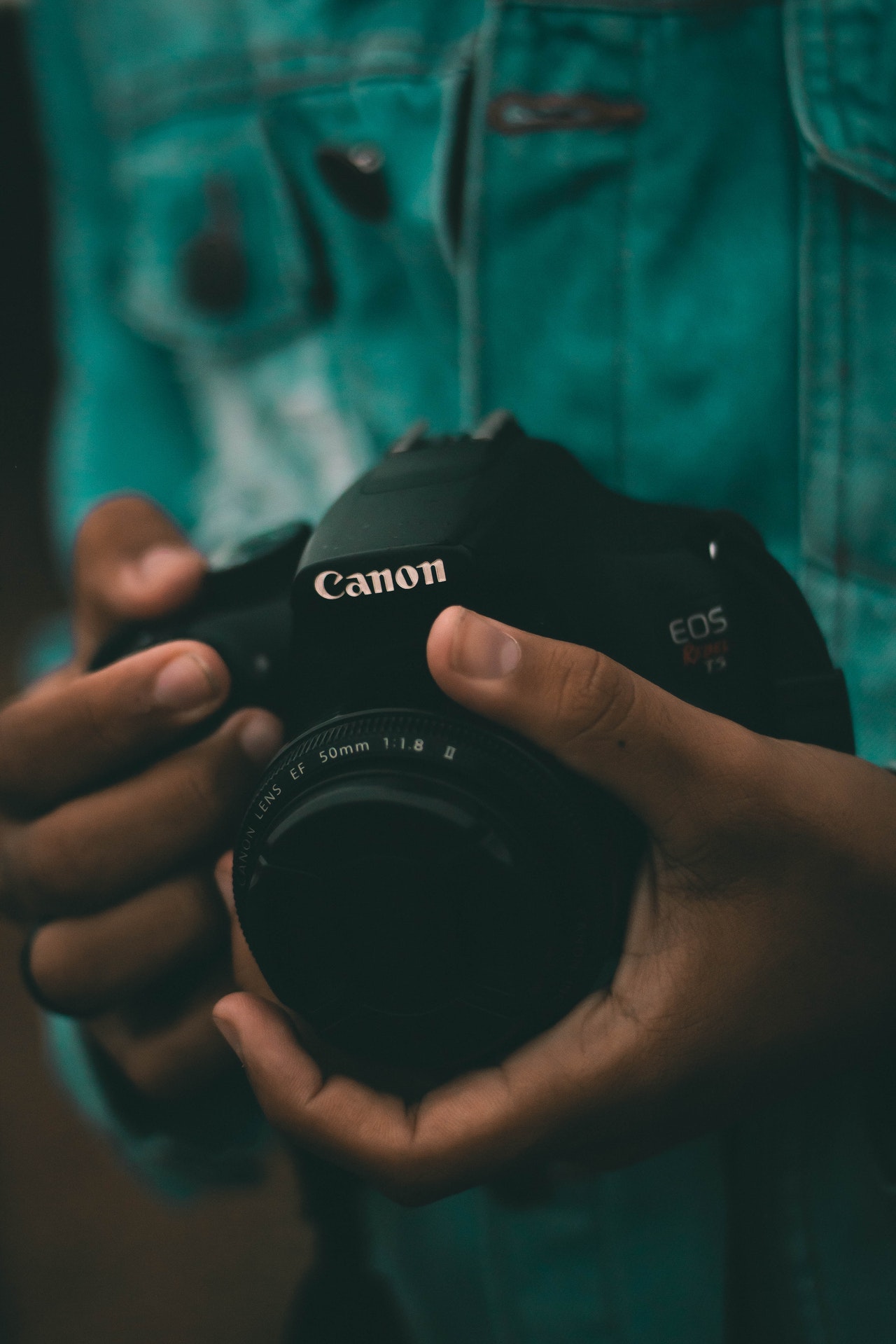 person holding black canon dslr camera