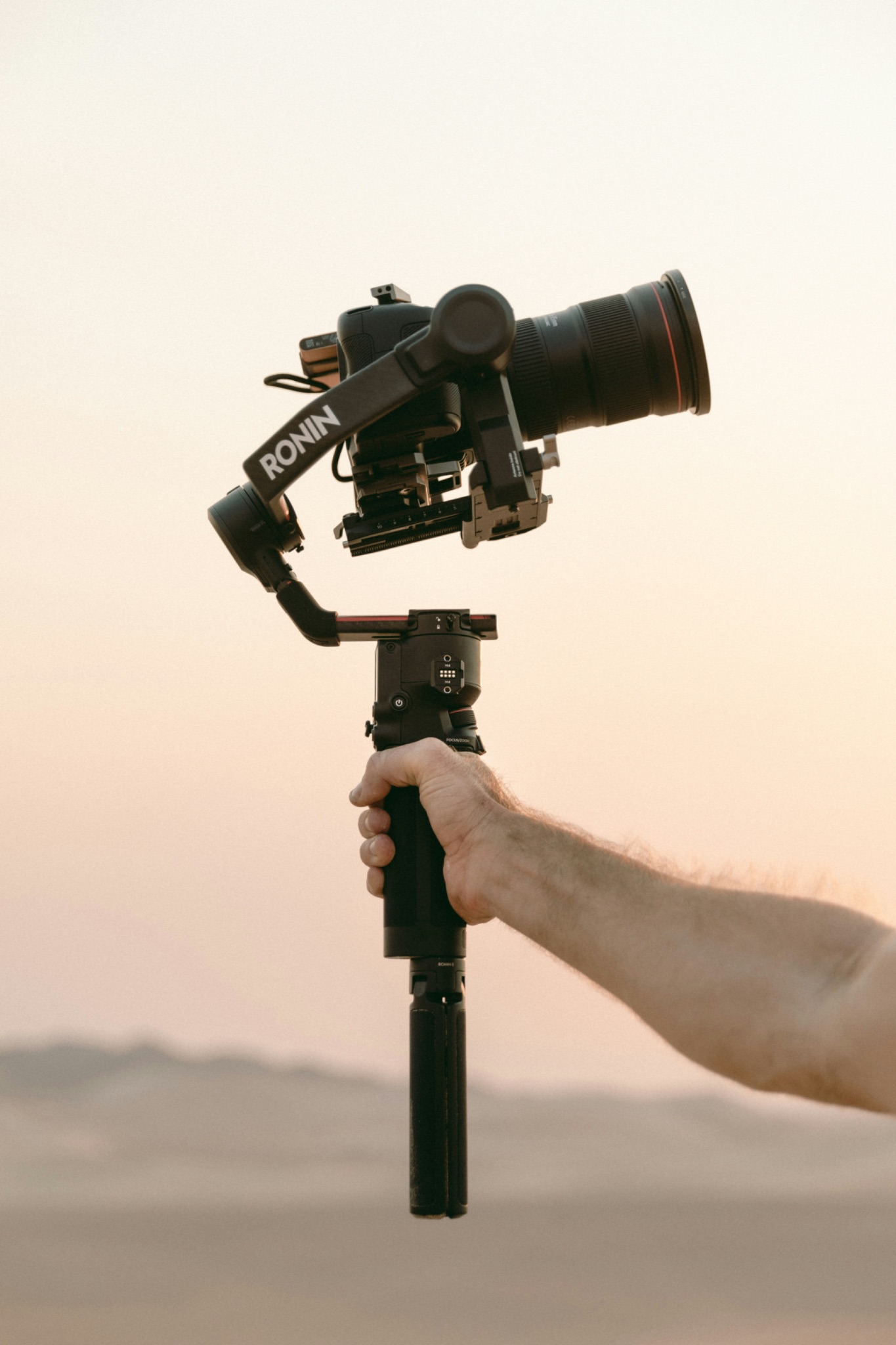 Person holding gimbal with Canon camera