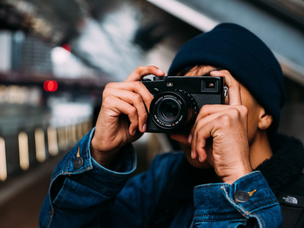 person taking photo using a camera