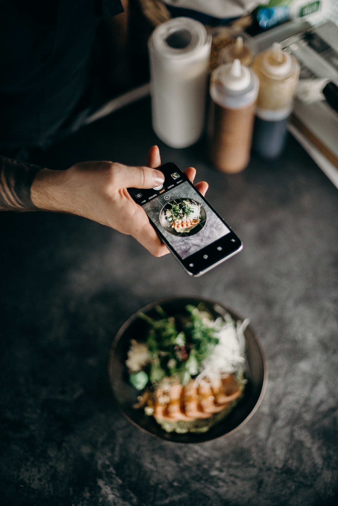 person taking photos of food