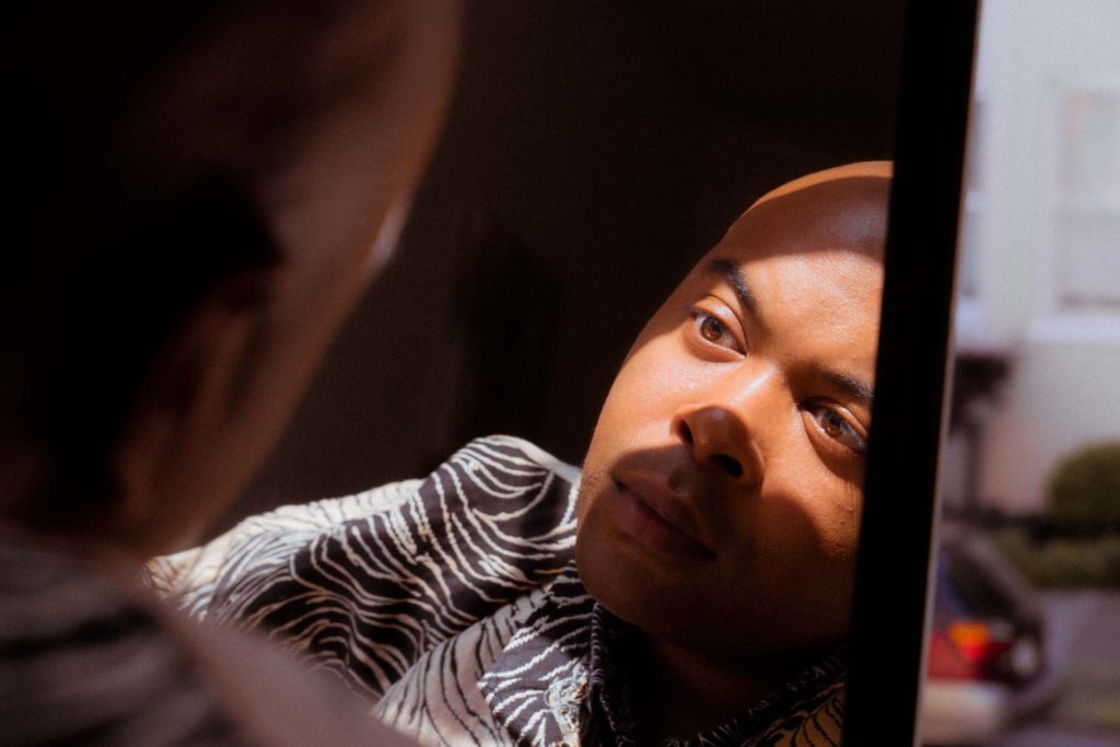 Dutch Angle portrait of man with reflection in the mirror