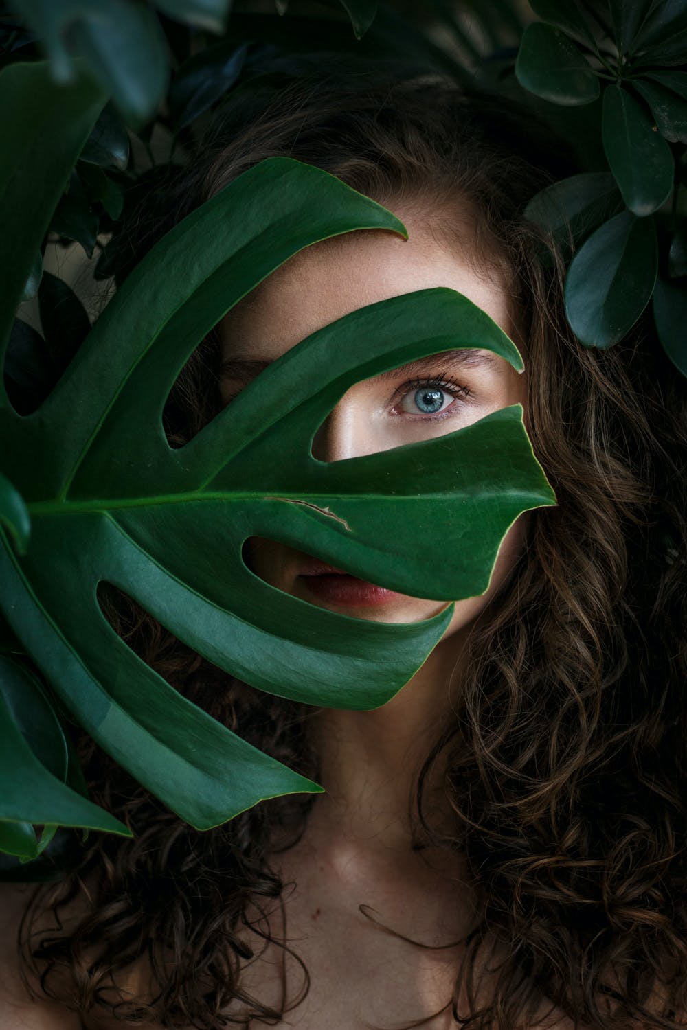 Girl behind leaf