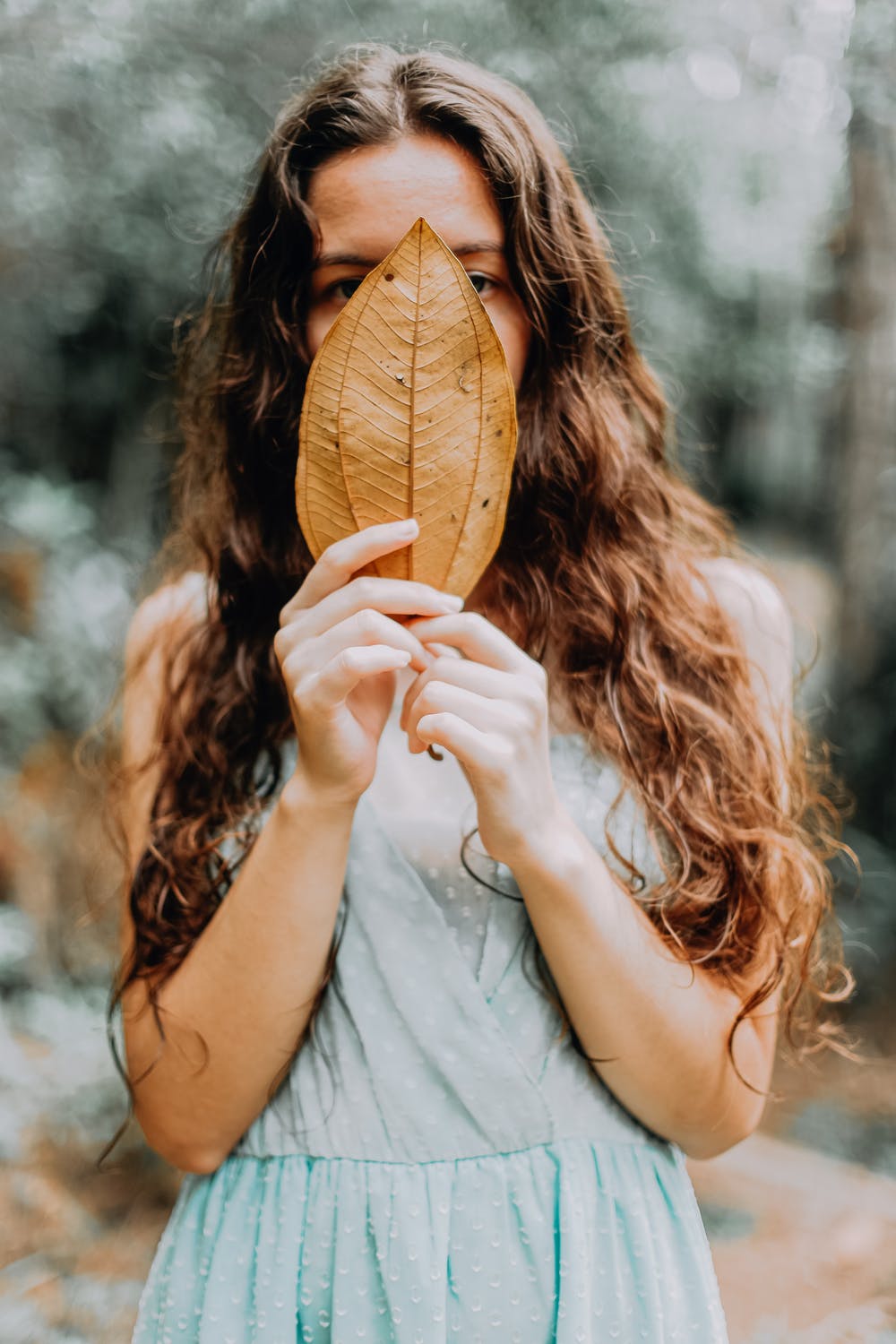 Woman behind leaf