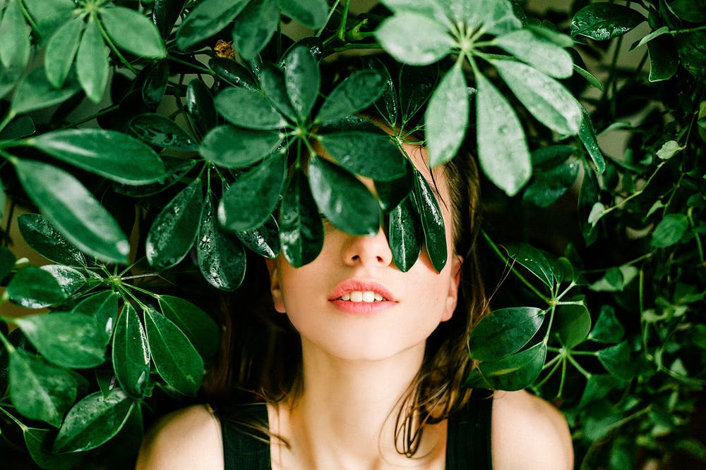 Girl behind leaves