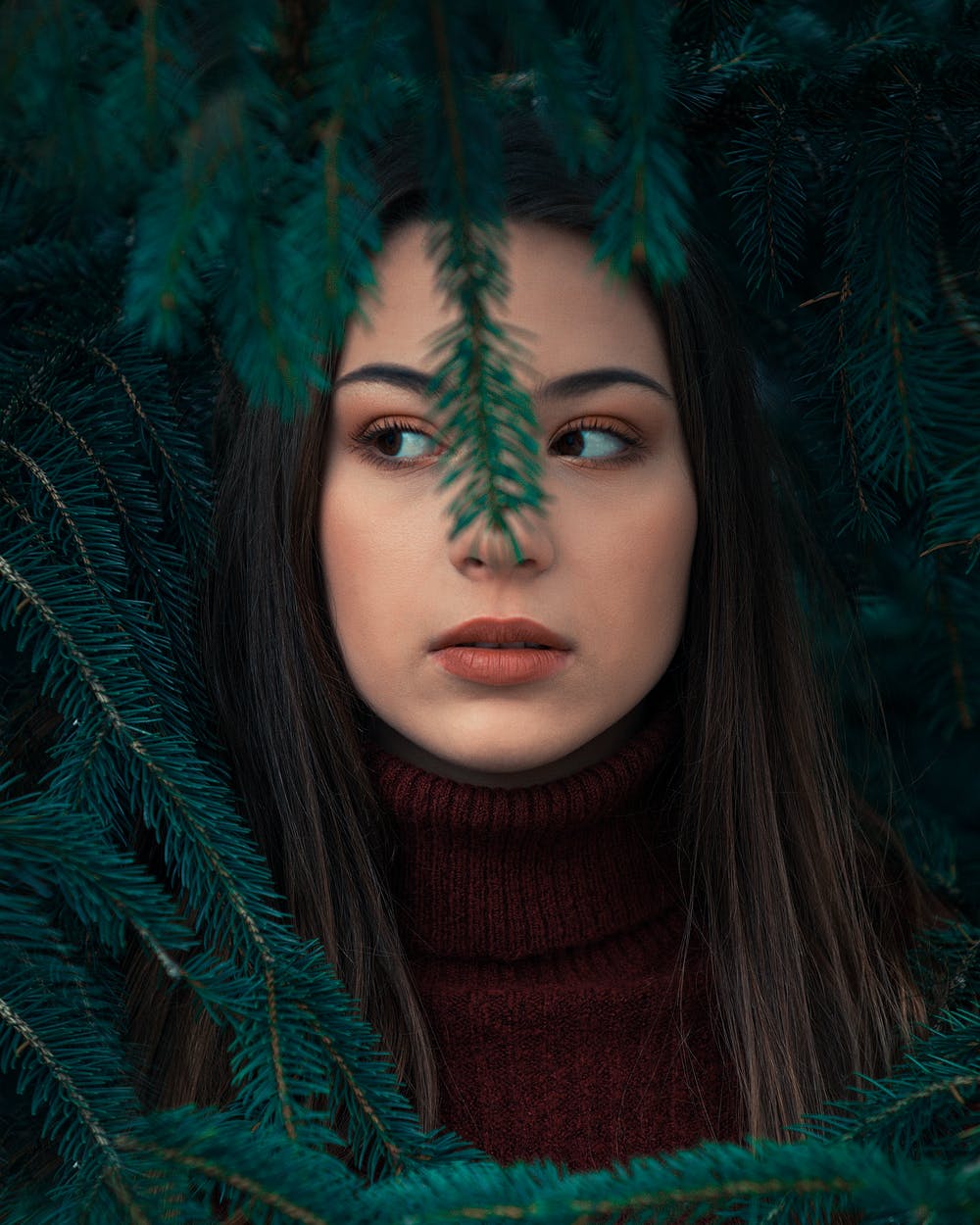 Girl behind branch