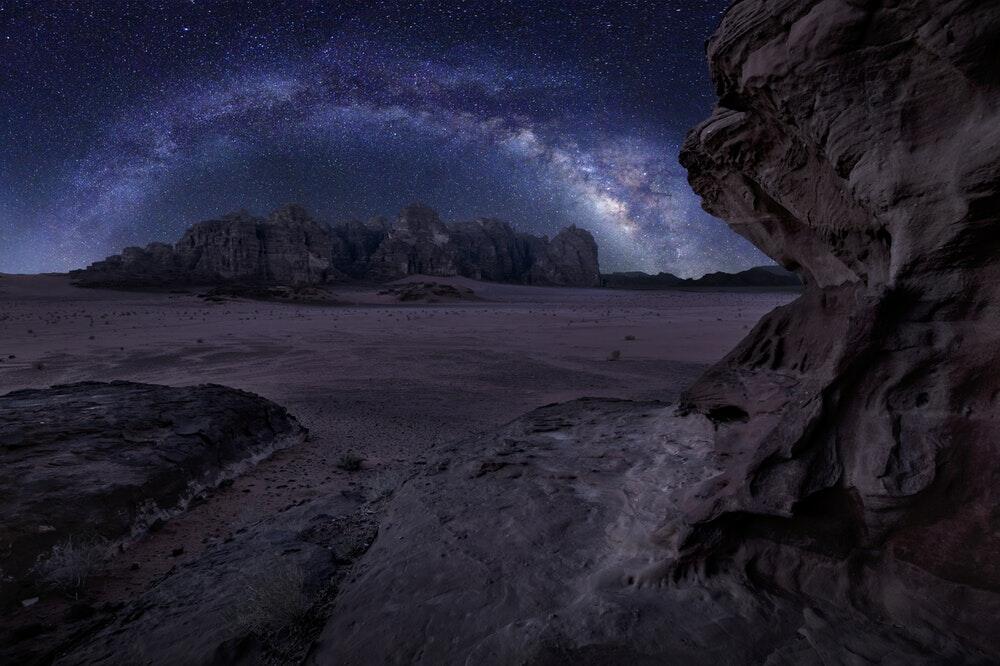 a rocky beach with a cave