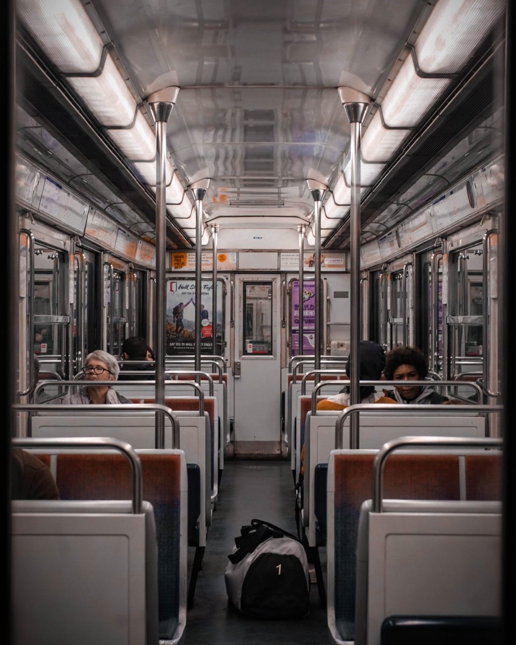 photo of people sitting inside train