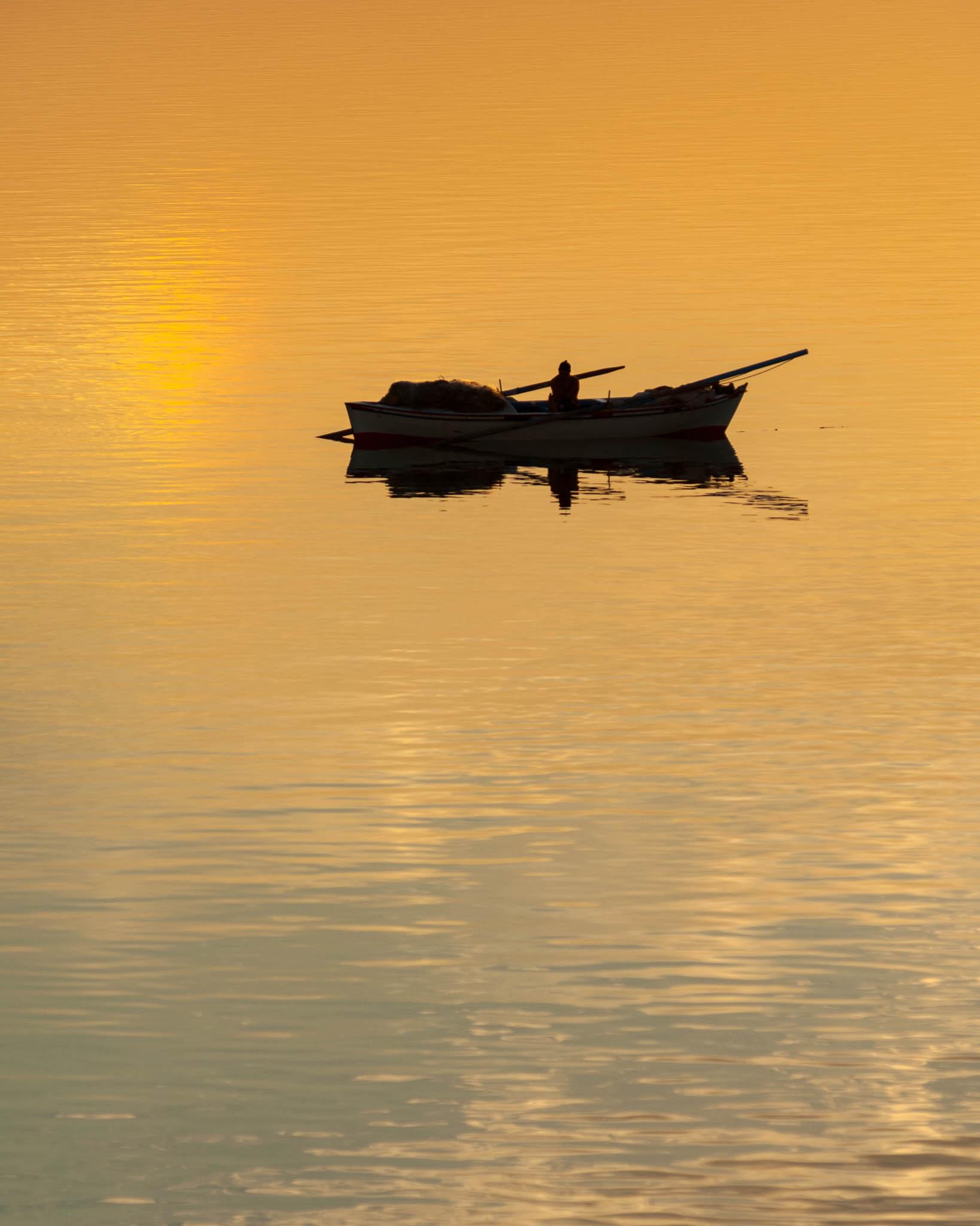 Picture of a fisherman in the Suez Canal demonstrating the negative space composition 