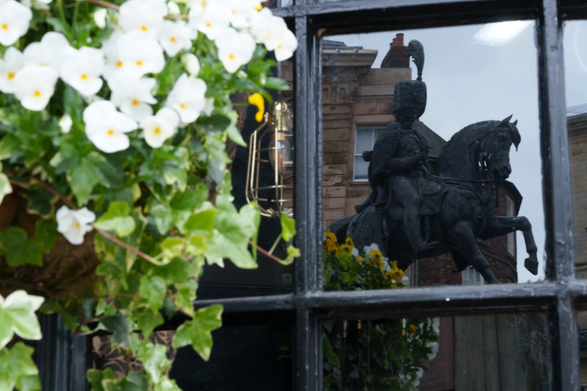 Reflection of a statue in the pub window in Durham, England