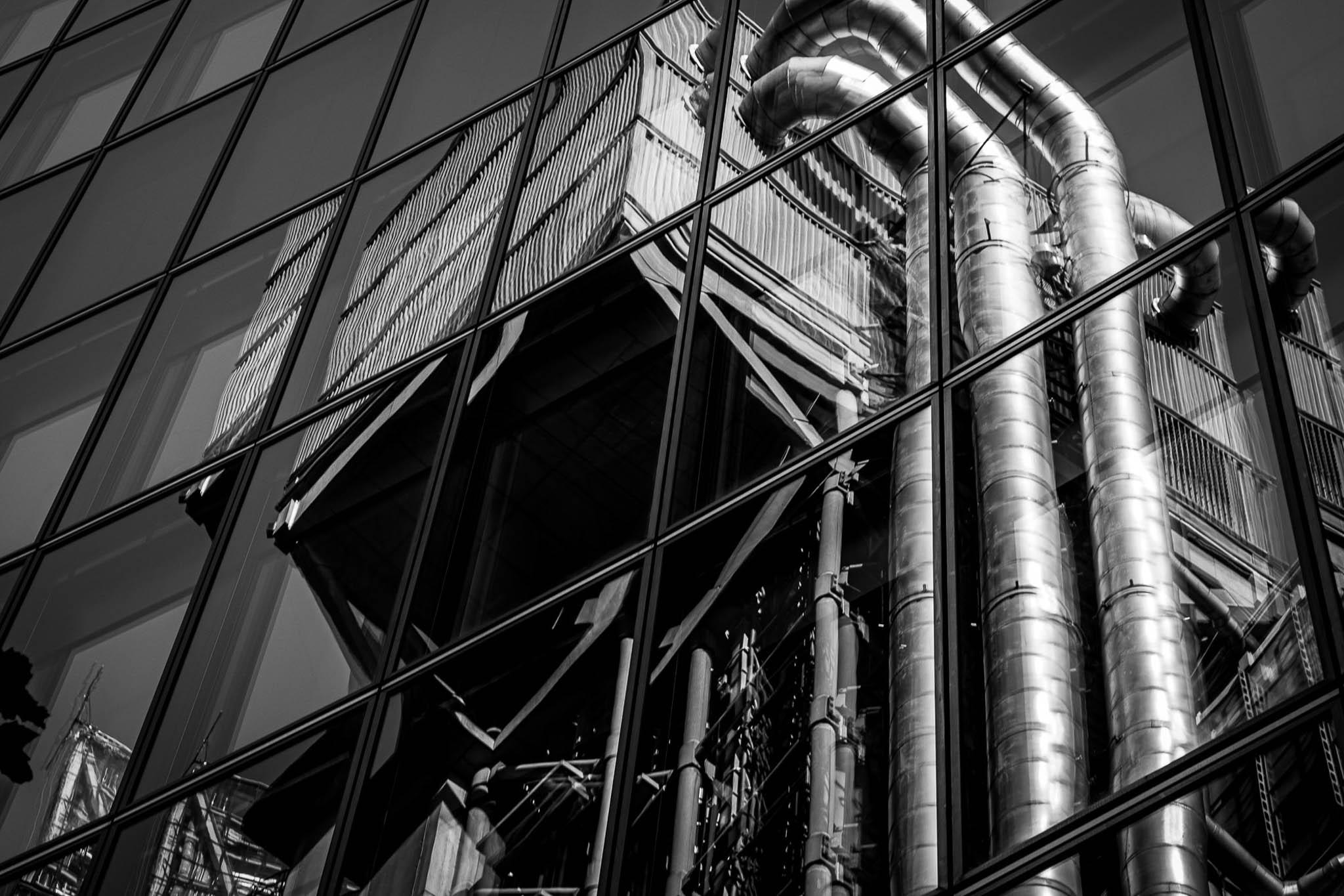 Reflections of the Lloyds building in London in black and white