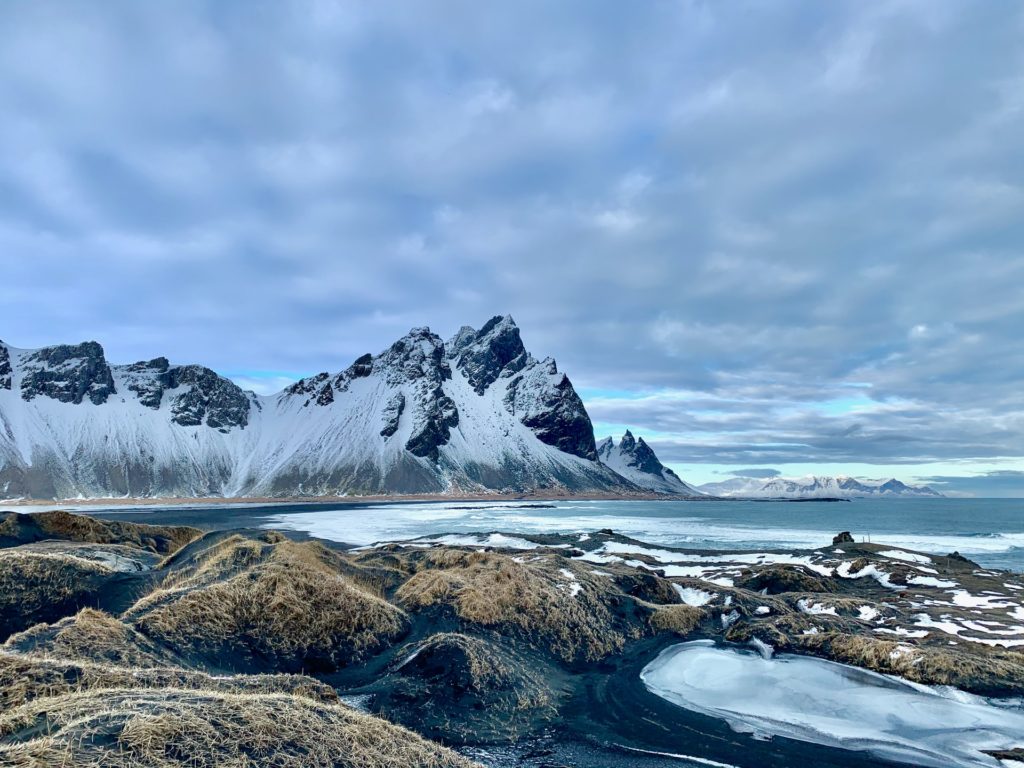 snow covered mountains by the sea