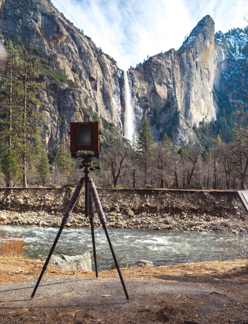 Large format camera in front of classic landscape