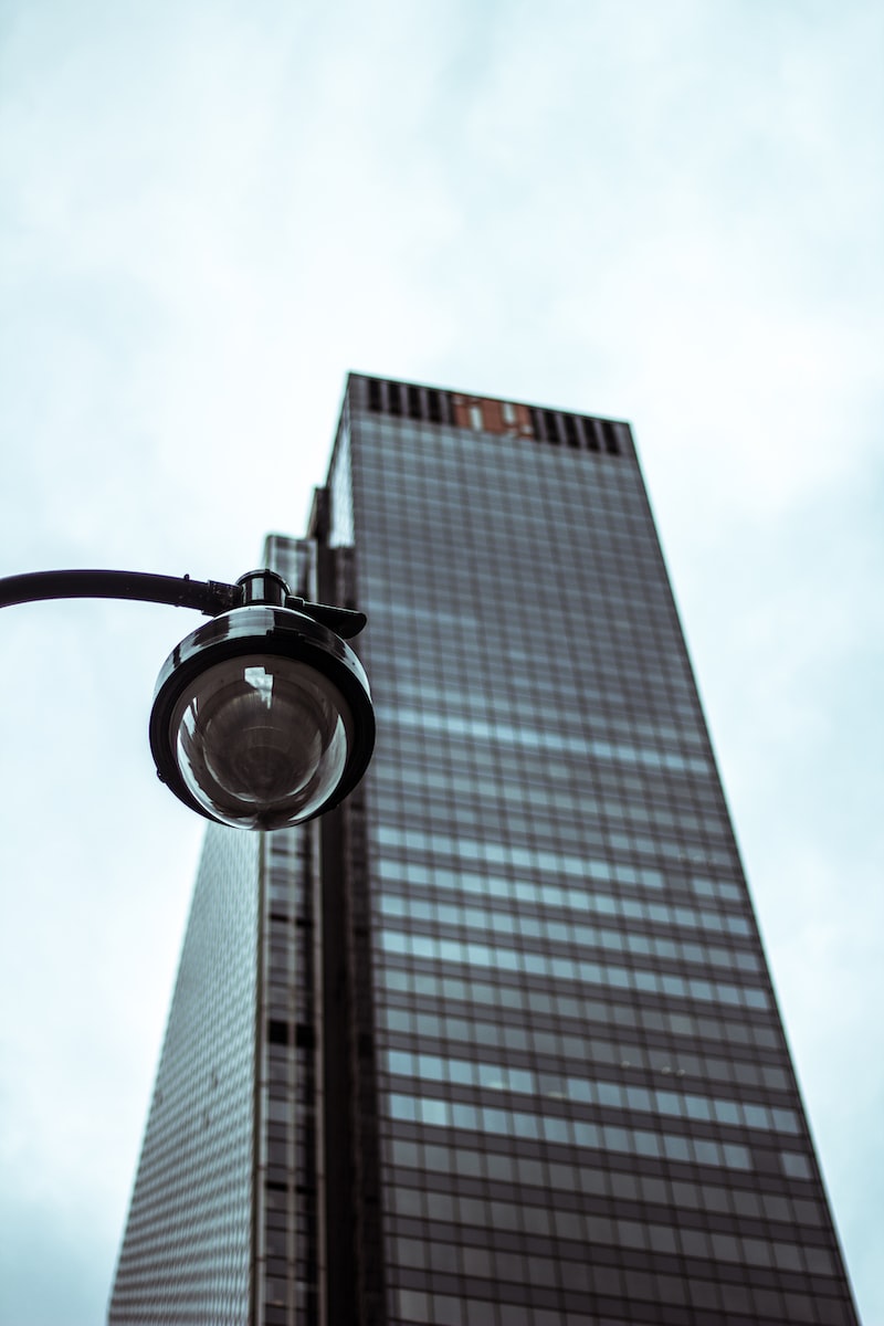 low angle photography of building with security camera in foreground