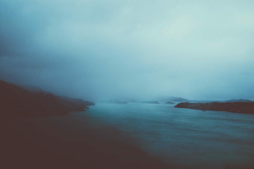 cloudy sky over calm body of water