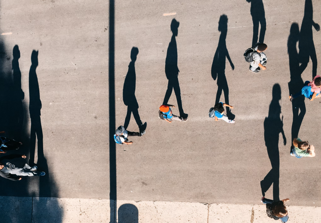 people crossing street shadows