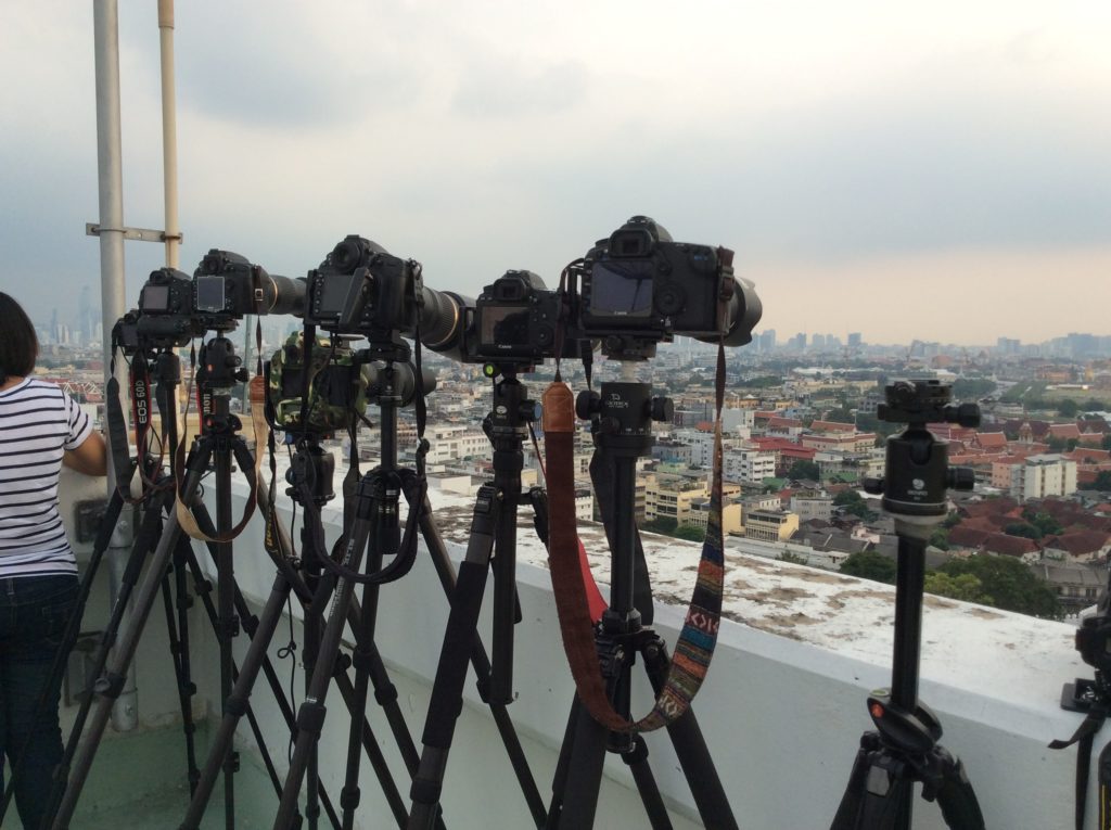 Row of tripods with cameras 