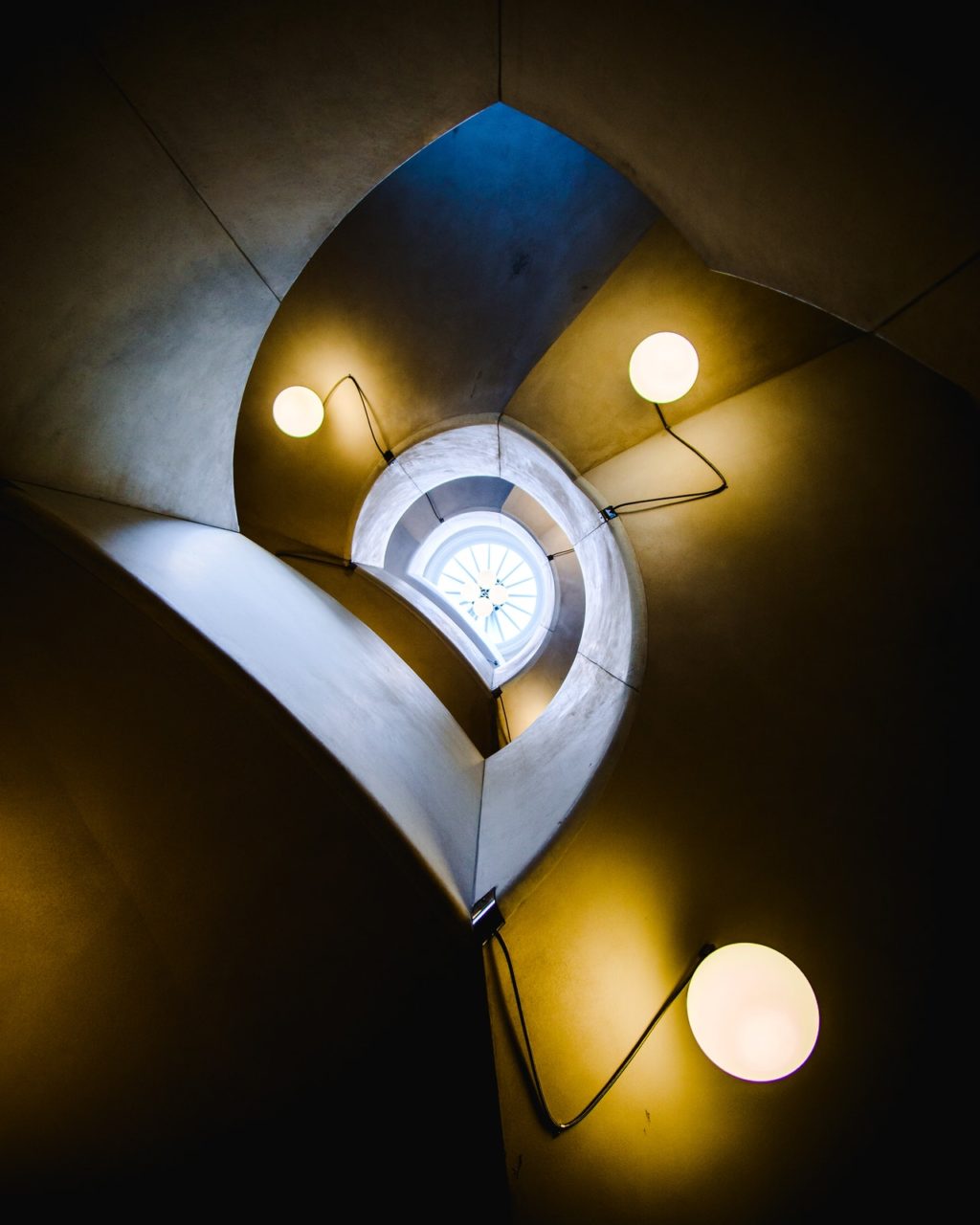 spiral staircase decorated with modern lamps