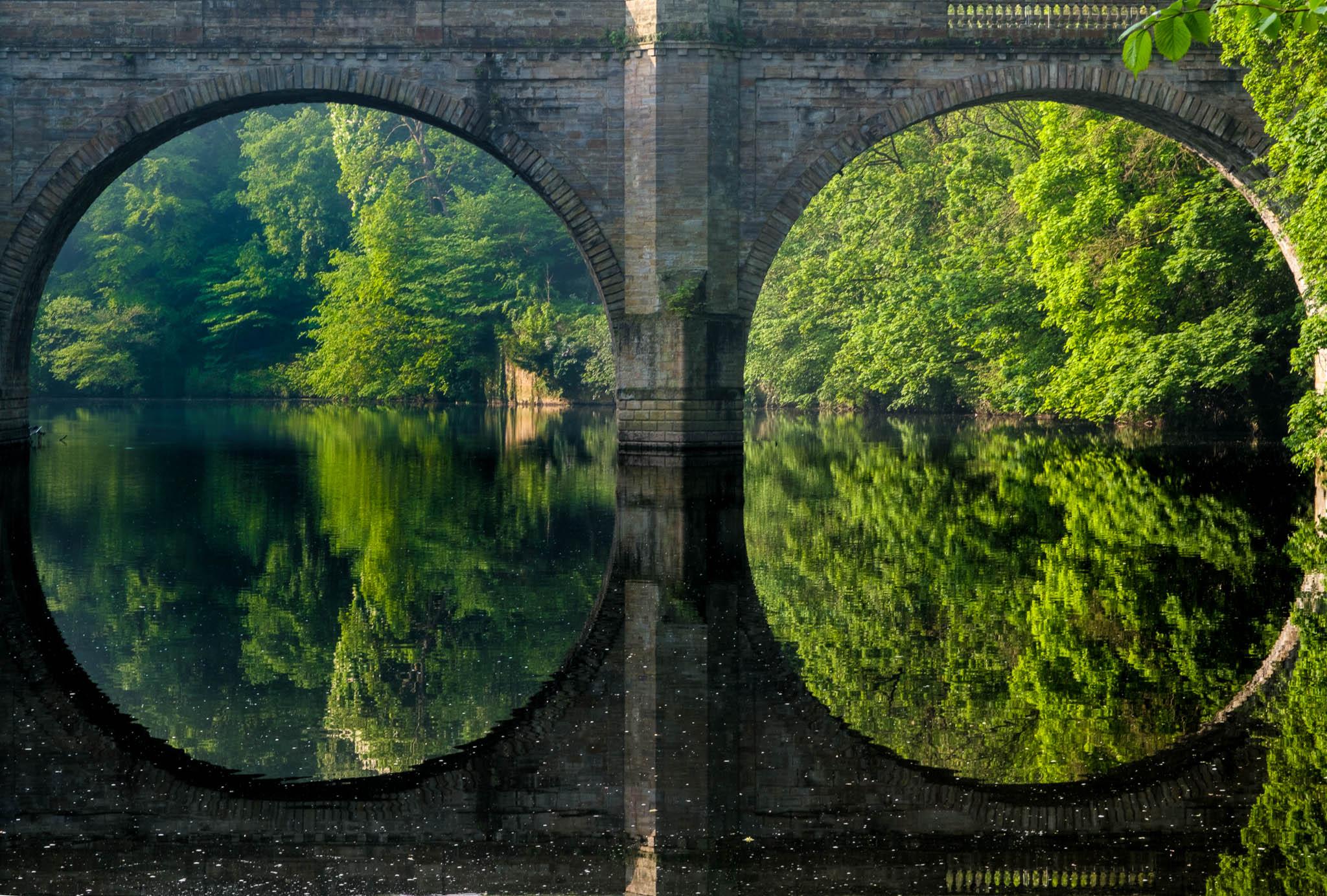 Stunning reflections of the arches of Prebends Bridge in Durham, UK