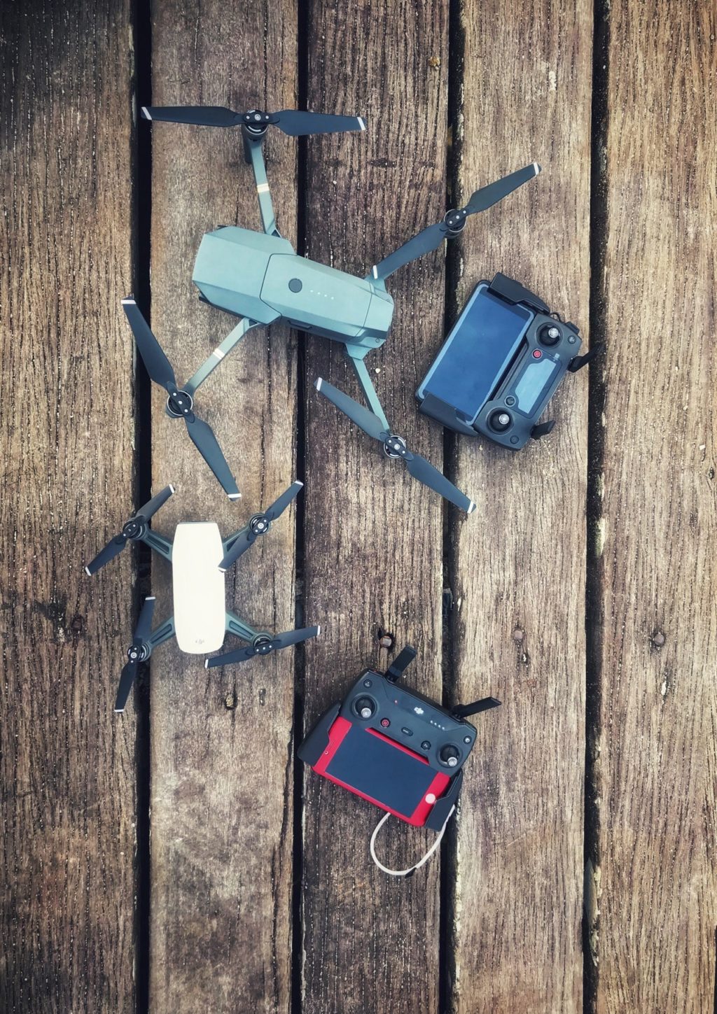 two assorted quadcopter drones with controllers