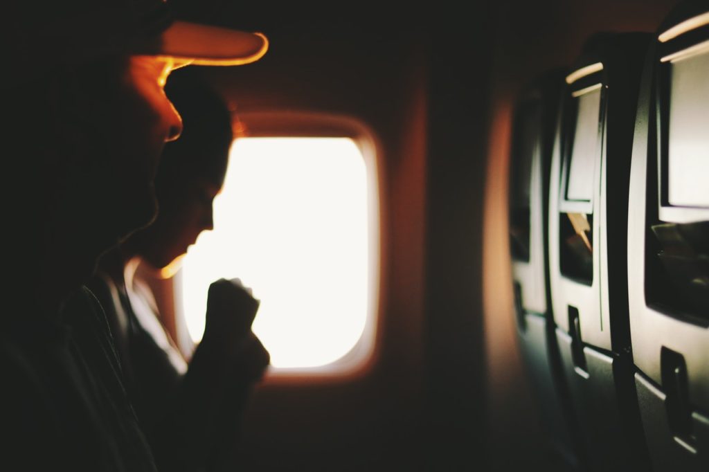 two people sitting near window inside plane