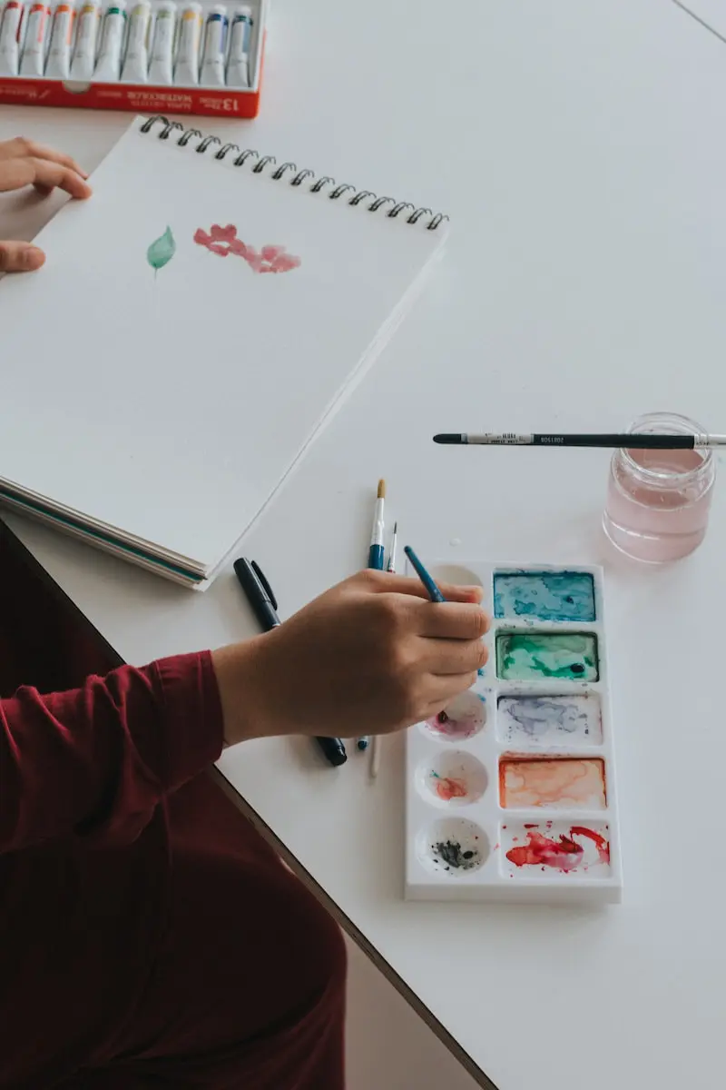 person dipping paintbrush on paint Photo by Rifqi Ali Ridho