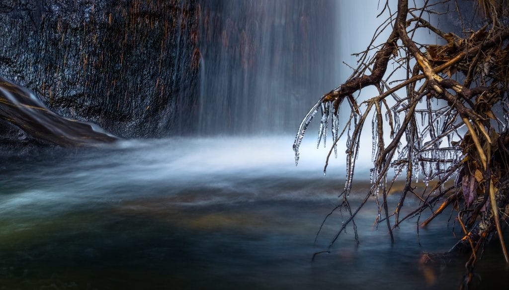 Waterfall with foreground branches