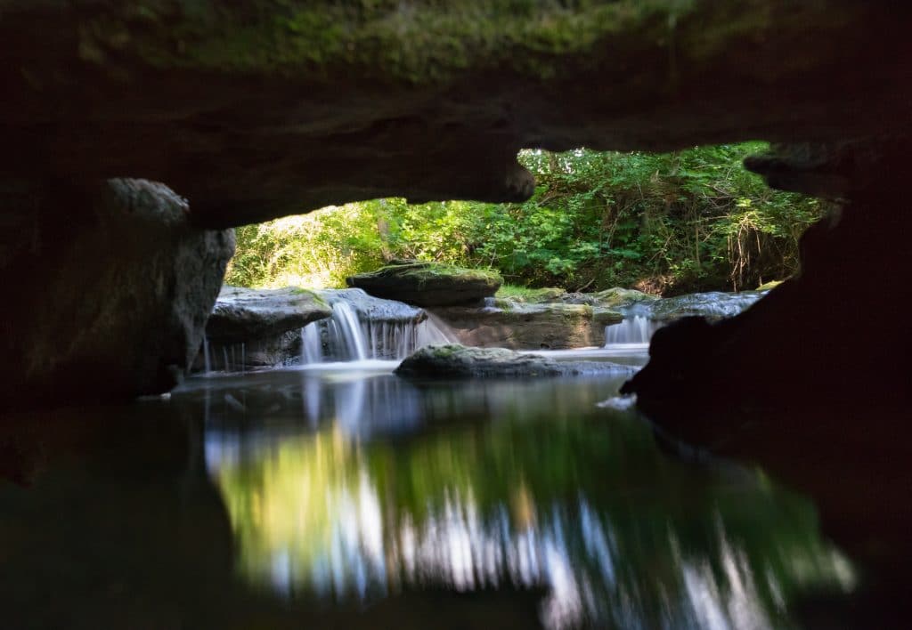 Waterfall looking through cave