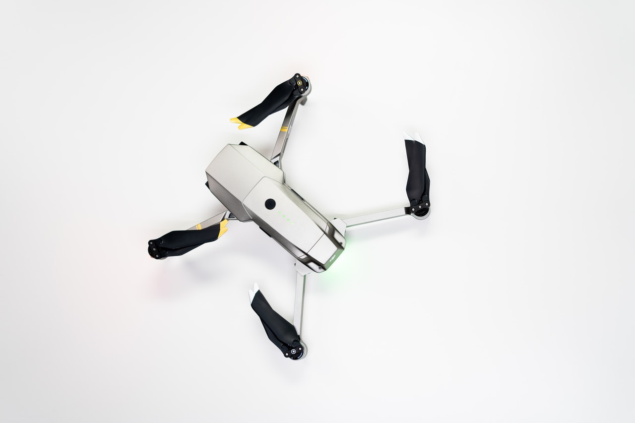 white and black drone on white surface