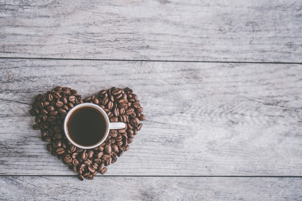 white ceramic mug filled with brown liquid on heart shaped