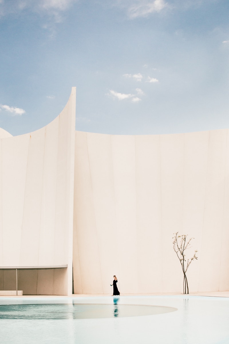 woman standing in front of white building