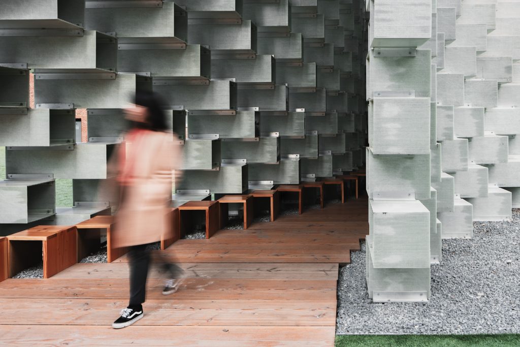 woman walks on wooden pathway