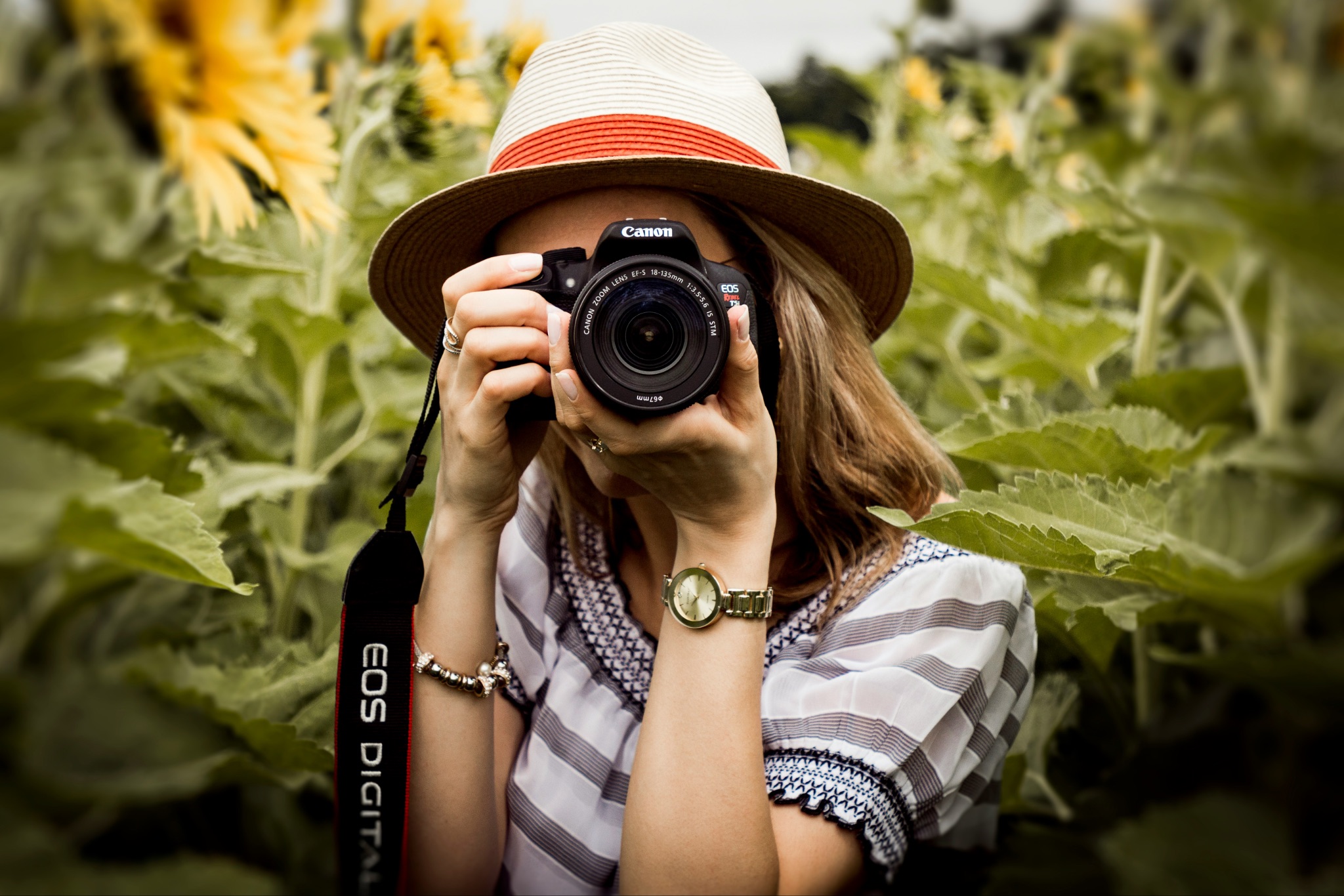 Woman with Canon camera photographing plants