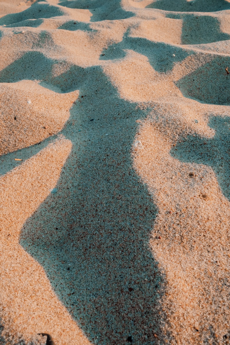 brown sand with shadow of person